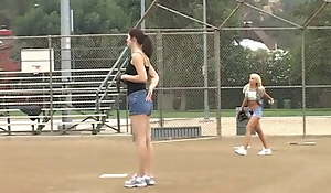 Coach shows 2 female athletes how with reference to rightly handle a beamy bat